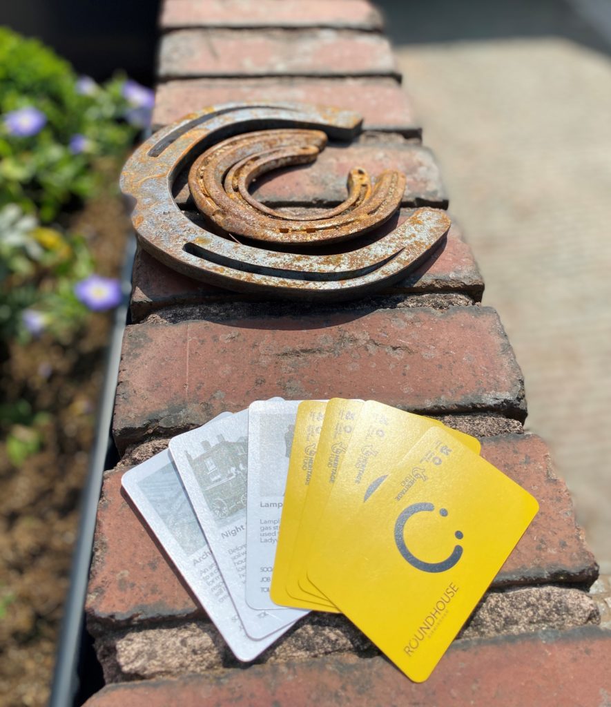 Picture of Roundhouse Top Trumps and different sizes metal horse shoes on a Roundhouse wall - hints about our Introducing the Roundhouse guided tour (2021)