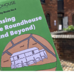 Picture of the Sensing the Roundhouse (and beyond) leaflet in focus with blurry picture of the Roundhouse courtyard in the background