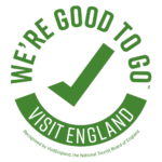 Good To Go Visit England Logo - green writing on grey and white chequered background