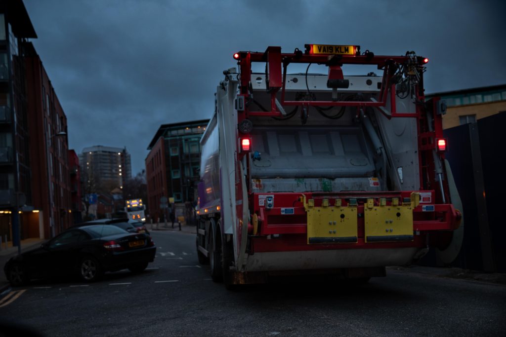 Bin Man by Ahsen Sayeed part of the Night Photography Series . It depicts a refuse track on a Birmingham street at night.