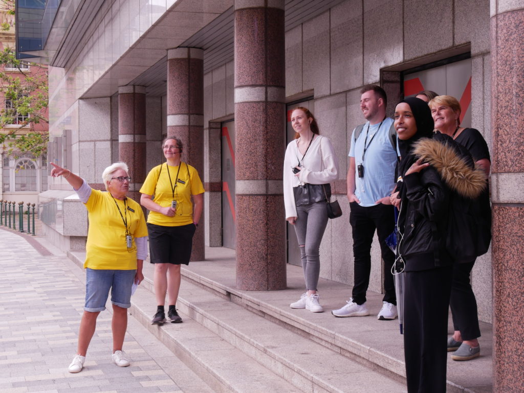 A group of visitors enjoy a guided walking tour of Birmingham from the Roundhouse