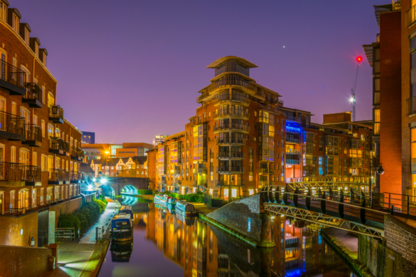 Picture of Birmingham canals at night with lights from buildings and street lighting reflected in the canal. The image was used for the Birmingham Bingo Evening Walking Tour 2022