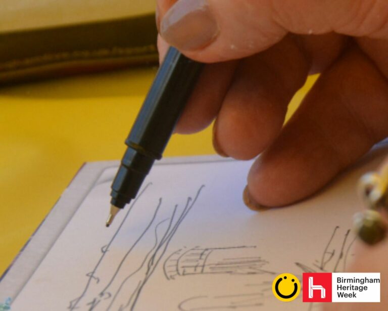 A landscape image showing a close up of a hand holding a black pen over a piece of white paper with a sketchy line drawing on. The background is yellow. In the bottom right of the image is a yellow smiley face logo and a red square with the letter h in.