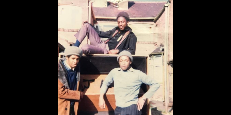 Three black men photographed in the courtyard at the Roundhouse. Picture part of the Wassif Sound System Collection