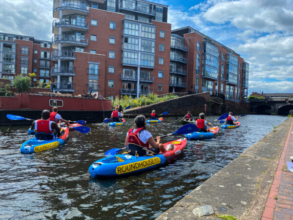 Group of kayakers on the Bustling Birmingham kayak tour about to set off from the Roundhouse.