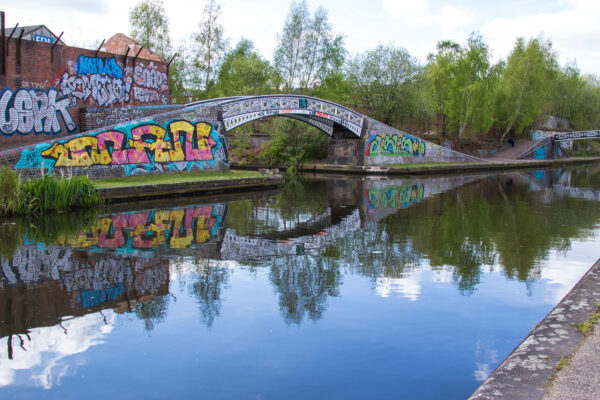Canal bridge with large amount of colourful grafitti