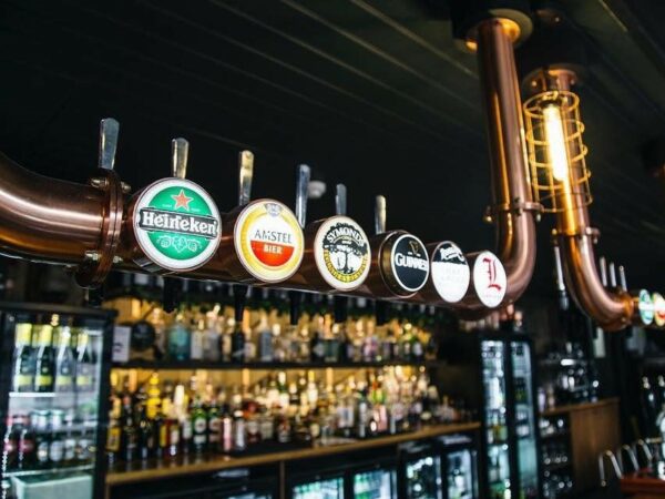 A landscape image showing a lie up of beer logos that are on tap in a pub.