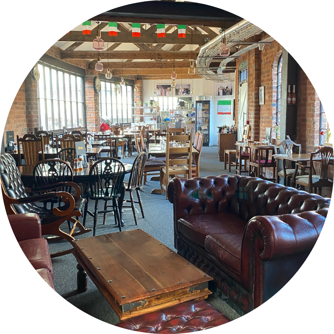 Inside the on site restaurant, Ristorante Caffe Arena. Eclectic mix of wooden furniture with Italian flags hanging from the beams above.
