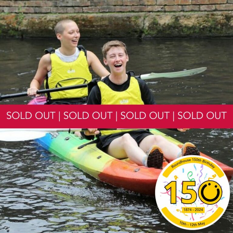 A square image showing two people in one rainbow coloured kayak on canal water. They are both wearing yellow buoyancy aids. In the bottom right of the image is a graphic logo with the number 150, the 0 of the logo is a yellow smiley face logo. The numbers 1 and 5 both have a black outline. Across the middle of the image is a red banner with the words, 'Sold Out' written. It is repeated 4 times.