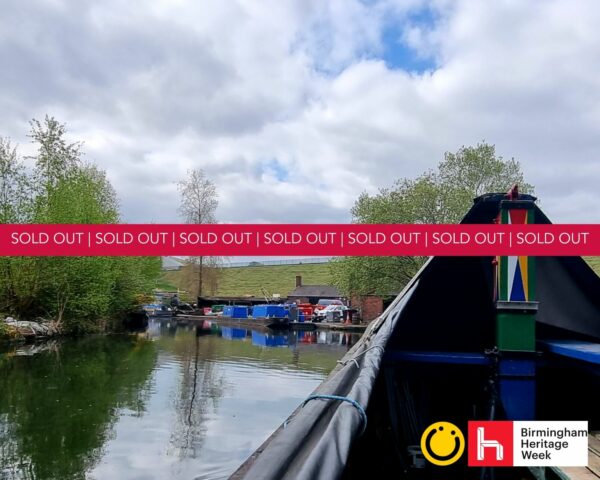 A landscape image showing a front of the end of a heritage working boat and a landscape in the distance. Across the middle of the image is a red banner with the words sold out on.