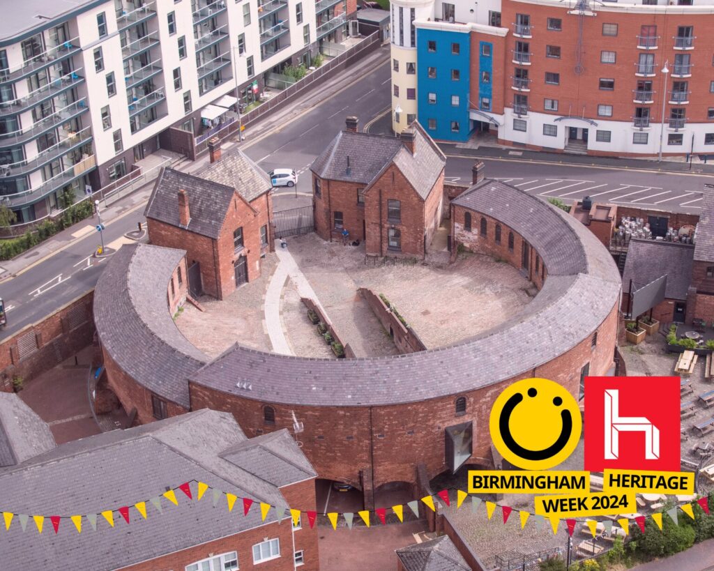 A landscape image showing a large curved roofed building with two large gatehouses. On the floor is a white paved path curving around the side of the building. There is a red hue to the image. In the bottom right corner is a logo - a smiley face in a yellow circle, a red square with a white lowercase h in and the words 'Birmingham Heritage Week 2024' in a black font on a yellow background. Across the bottom of the image are some graphics of bunting in colours red, yellow and grey.